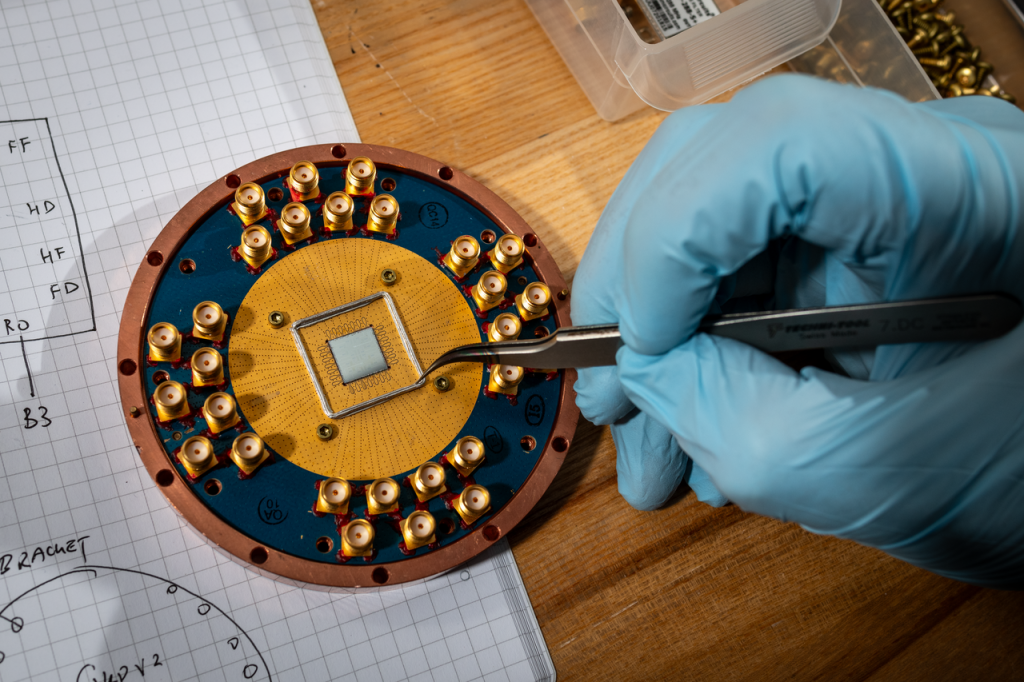 Long Nguyen, Computational Project Scientist, Applied Mathematics &amp; Computational Research, inspects a Sample Box at the Advanced Quantum Testbed laboratory on the UC Berkeley campus,